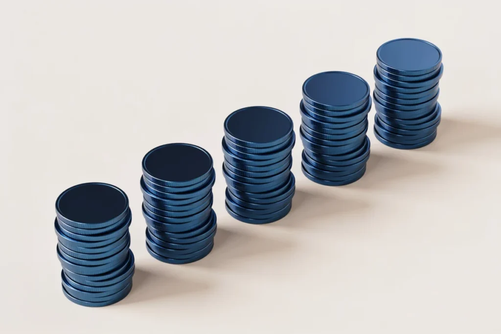 A row of navy coin stacks growing steadily, representing regular investing over time