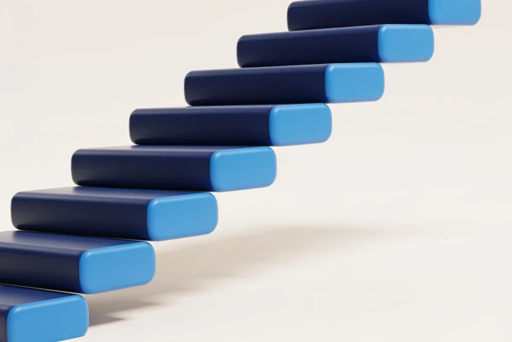 An ascending navy blue staircase of blocks, symbolizing steady progress toward financial independence